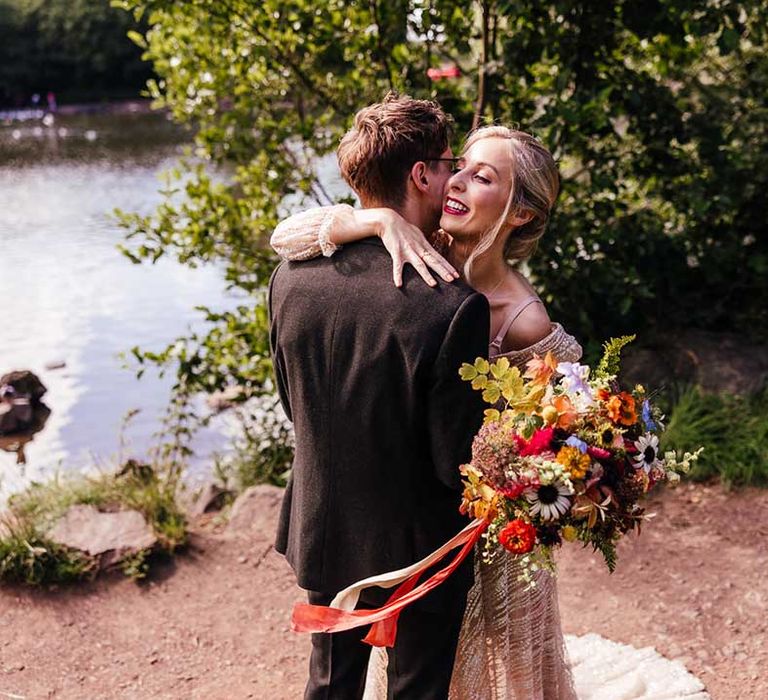 Bride & groom hug after first look moment on their wedding day