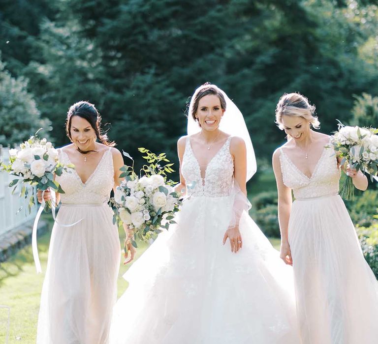 Bride in a princess wedding dress and bridesmaids in needle and thread white bridesmaid dresses 