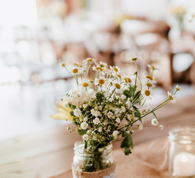 Small arrangement of gypsophila and daisies and other white flower for table decor