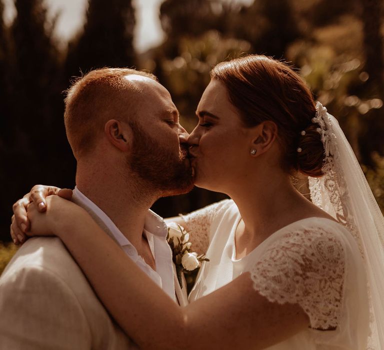 Bride & groom kiss outdoors after relaxed outdoor ceremony in Spain at the Finca Villa Palma 