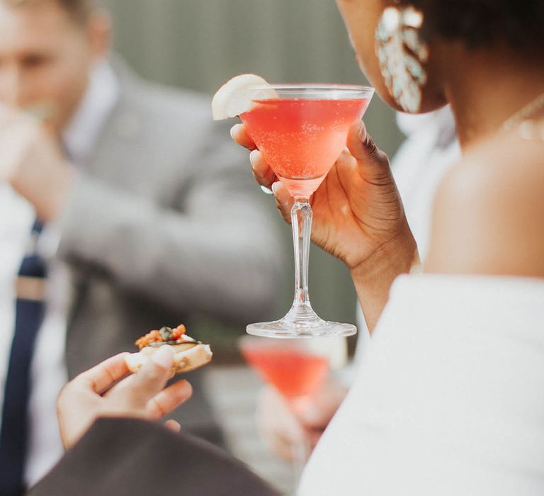 Wedding guest drinks the signature cocktail for the wedding 