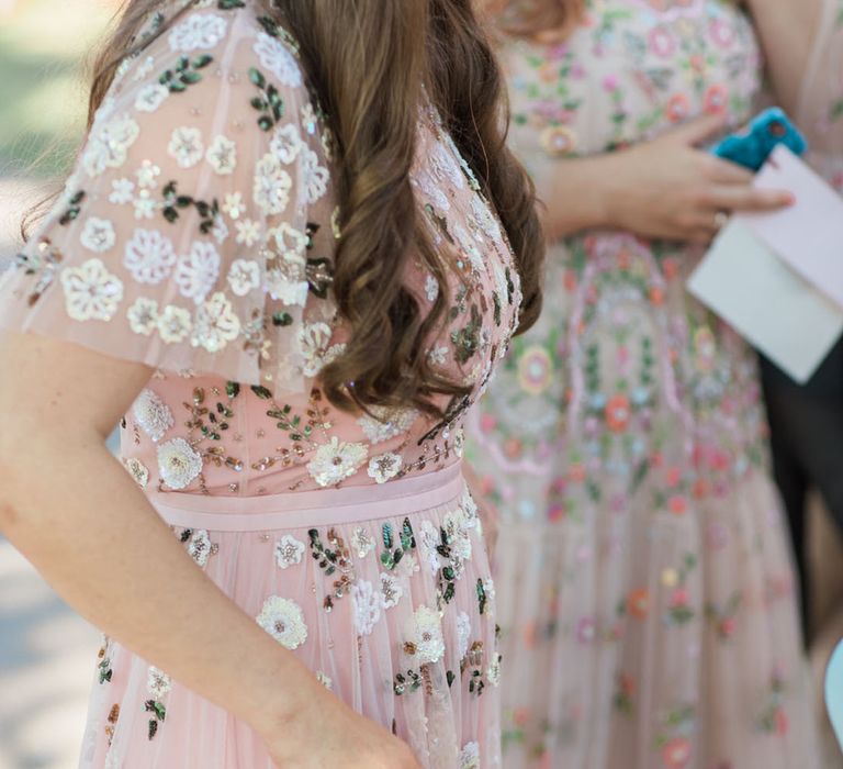 Pink delicately embellished bridesmaid dress with flowers, sequins, and beading 