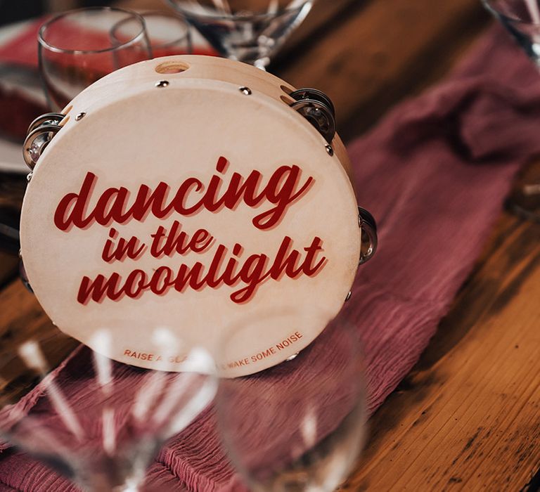 Tambourine wedding table names with a red retro font 