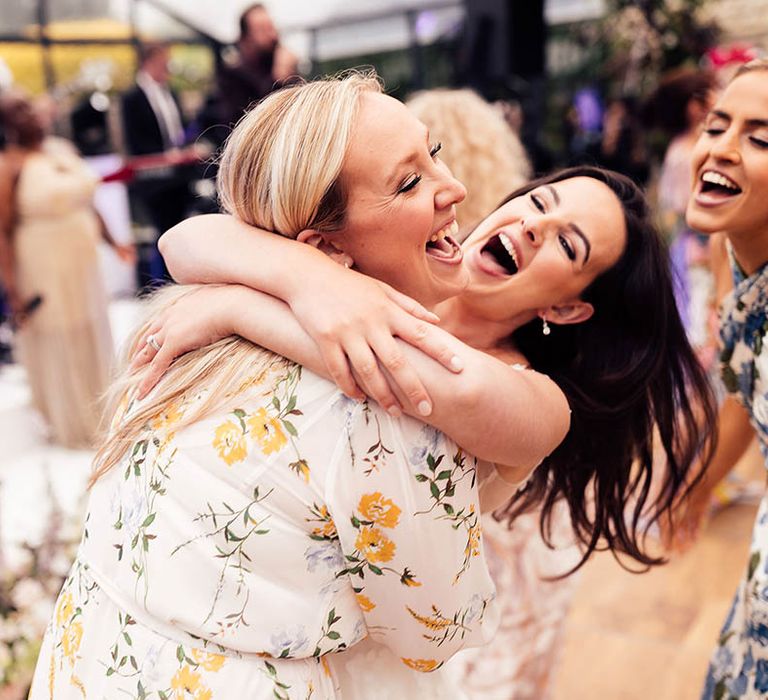 Wedding guest and bridesmaid dance with the bride during the reception 