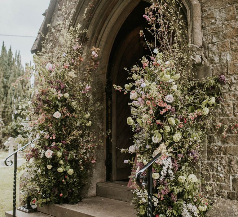 Wedding flower columns decorate the church wedding venue for the ceremony 