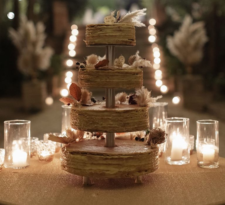 Four tier Opera wedding cake with pampas grass decor 