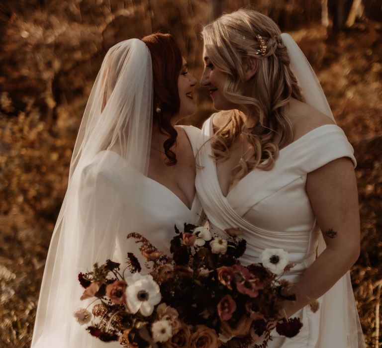 Bride in long sleeve deep v wedding dress and church length veil and bride in satin short sleeve deep v wedding dress and church length veil at Hidden River Cabins