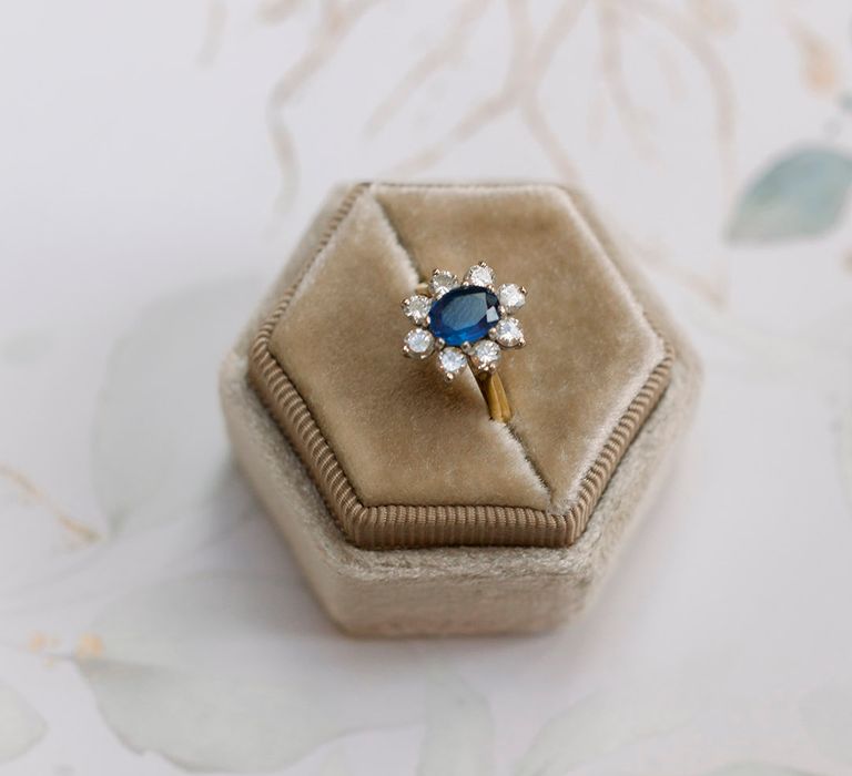 sapphire and diamond engagement ring in a grey velvet ring box 