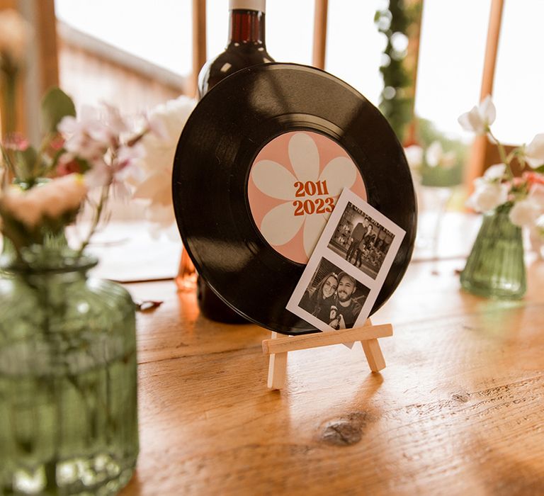 Vinyl wedding table number sign with Polaroid pictures of the couple 