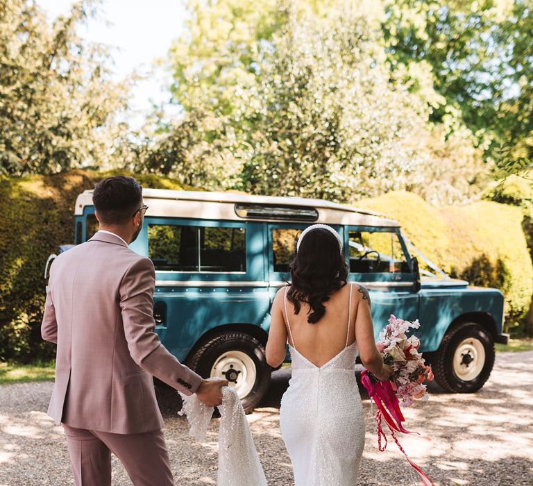 Blue Land Rover vintage wedding car waiting to take the bride and groom to their reception 