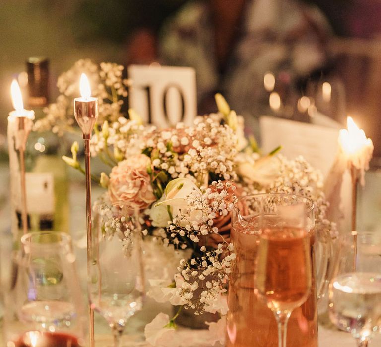 Wedding tablescape with candles, gypsophila and roses 