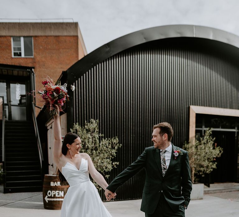 Couple portrait of bride and groom at their industrial wedding venue with an 80s theme 