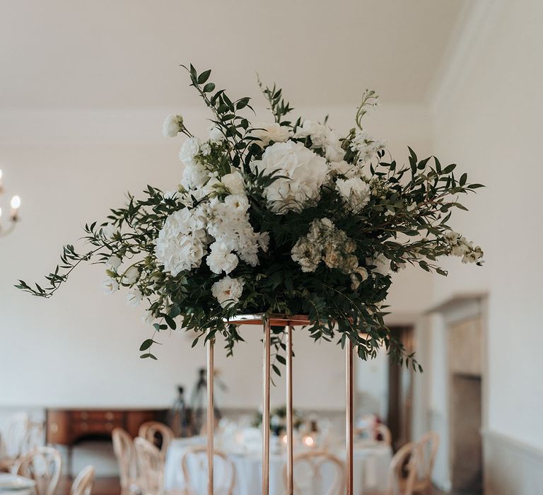 Tall white flower wedding table centrepiece with table name sign 