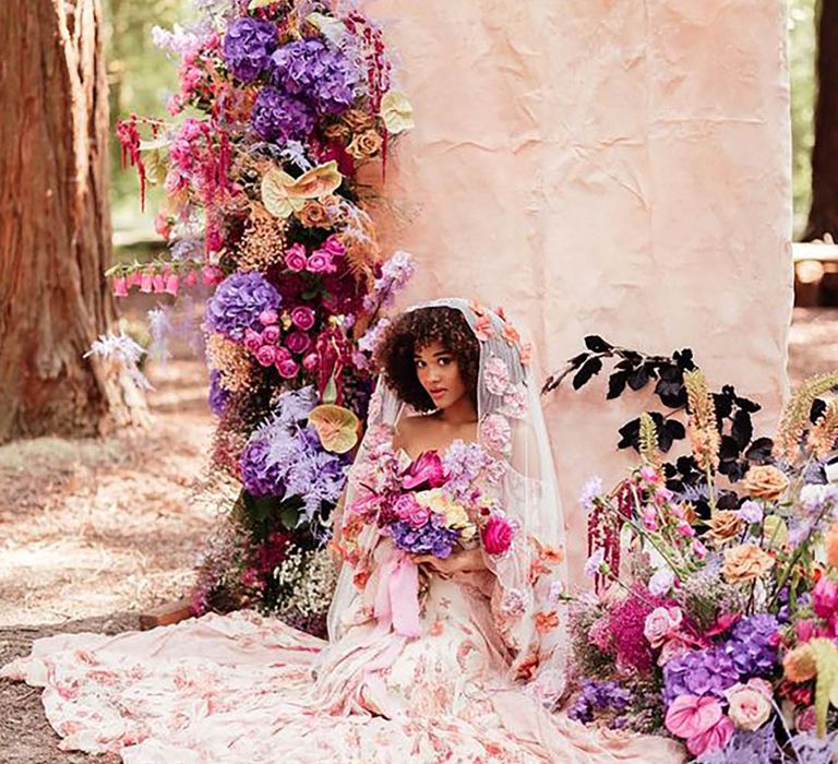 Floral themed editoral shoot with bride surrounded by beautiful flower bouquets while sitting on the floor in wedding dress by Kirsty MacKenzie Photography