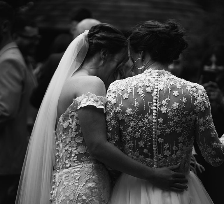 Brides in flower wedding dresses dancing at their wedding reception 