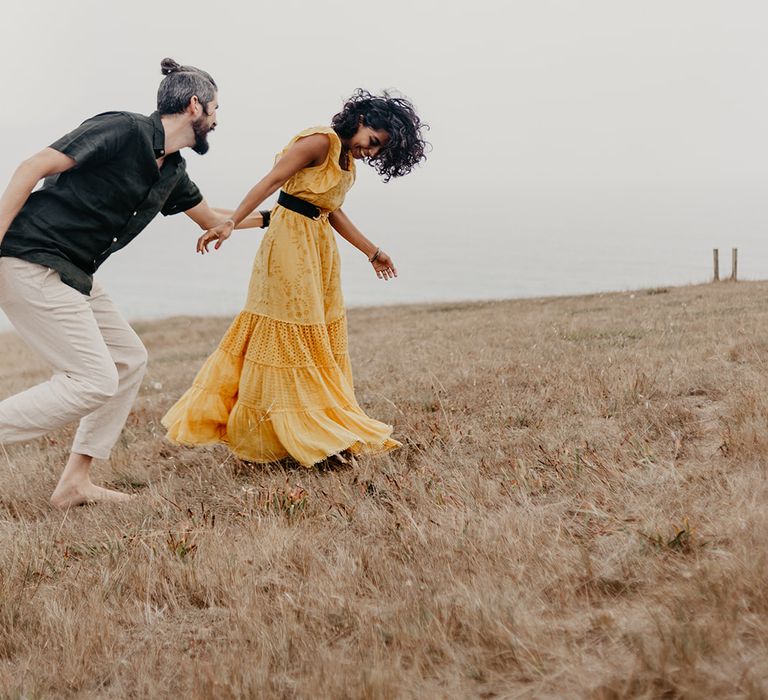 Bride and groom laughing at coastal elopement 