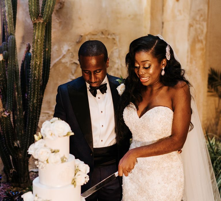 Bride and groom cutting the wedding cake at Syon Park 