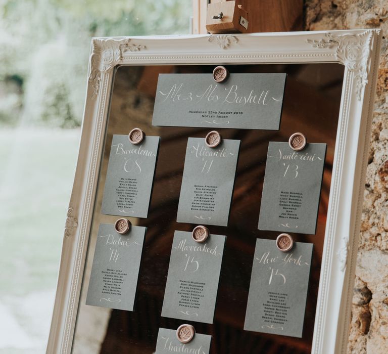 Mirror table plan with ornate frame and wax seals 