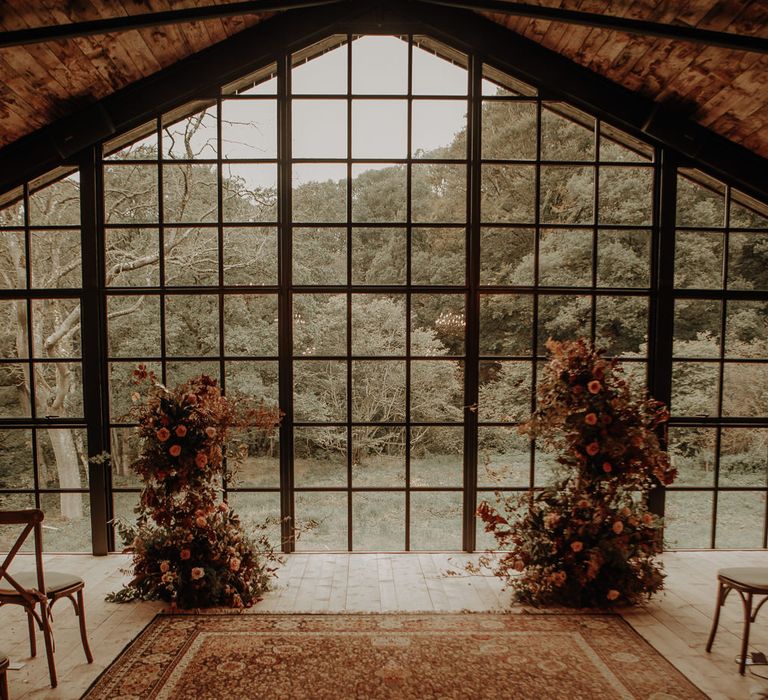 Aisle and altar wedding decor with moroccan rug and autumn flowers 