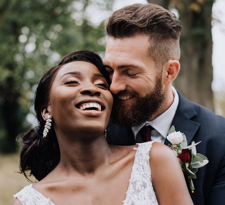 Wedding portrait of the bride and groom laughing 