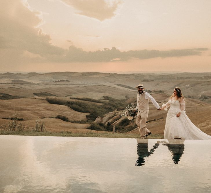 Bride and groom look over Tuscany olive groves