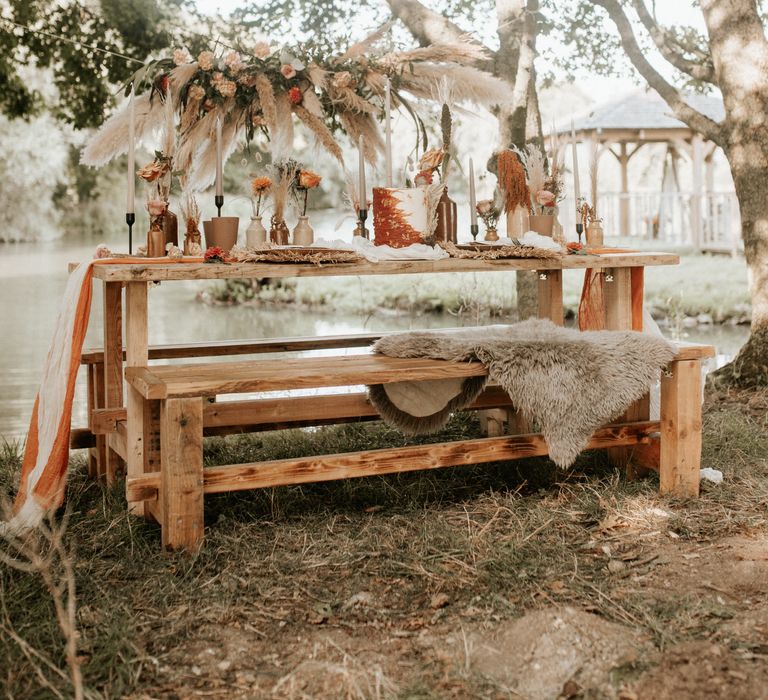 Boho chic outdoor table decor with Autumnal colour scheme and pampas grass arch 