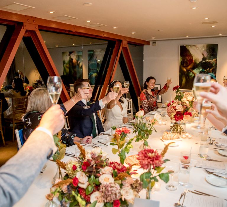 Micro wedding guests raising a glass