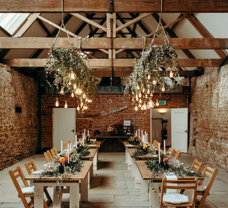 Rustic wedding venue with hanging ivy and lighting