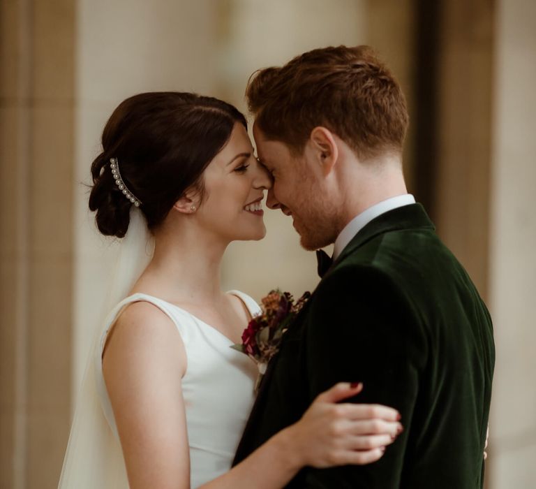 Bride and groom holding each other at autumn Manchester townhall wedding