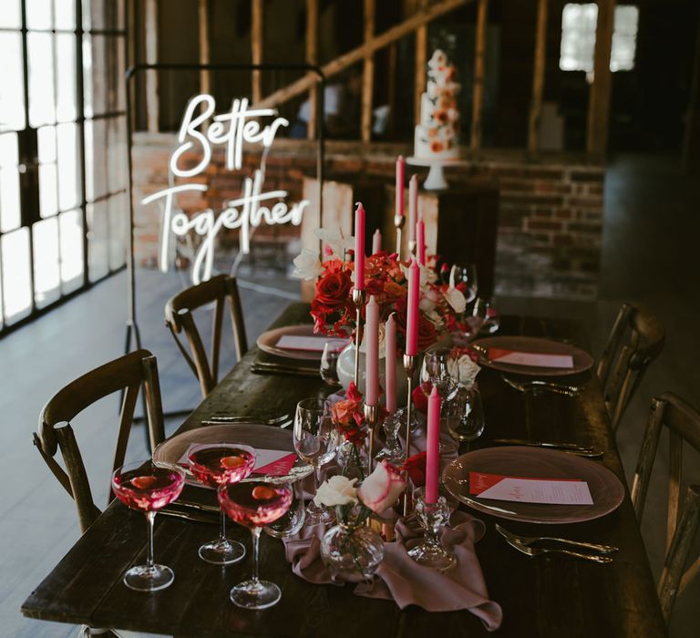 Coral tablescape with neon sign in the background