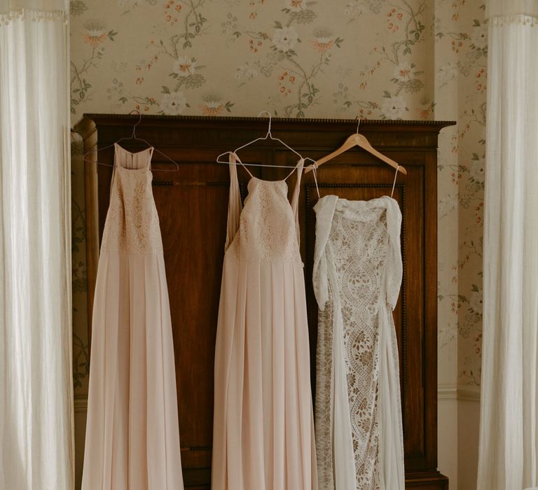 Grace Loves Lace wedding Dress and pink silk bridal dresses hang on wardrobe at Drenagh Estate wedding