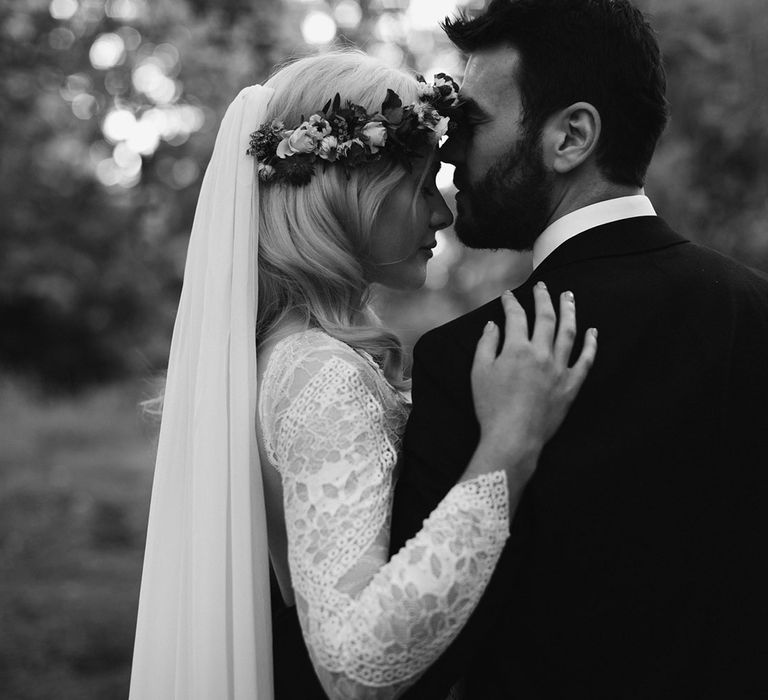 Bride in Grace Loves Lace wedding dress and single tier cathedral length veil hugs groom in black Hugo Boss suit at Drenagh Estate Wedding