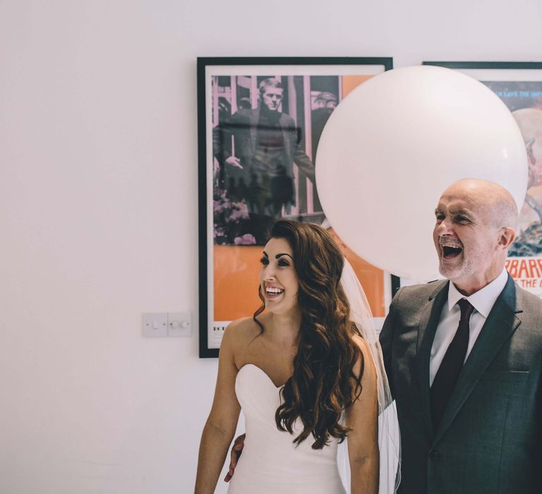 Bride and wedding guest laughing together