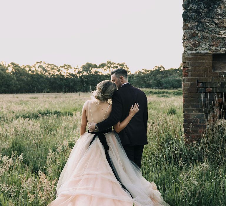 Amazing tulle skirt wedding dress for bride kissing groom