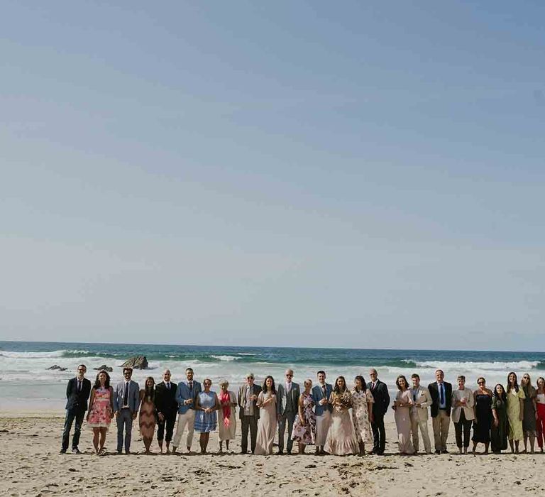 Wedding guests line up on Cornwall beach