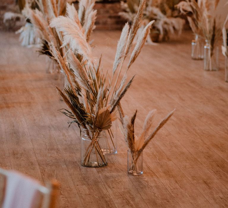 Wedding ceremony at Pryors Hayes with dried flower arrangements lining the aisle 