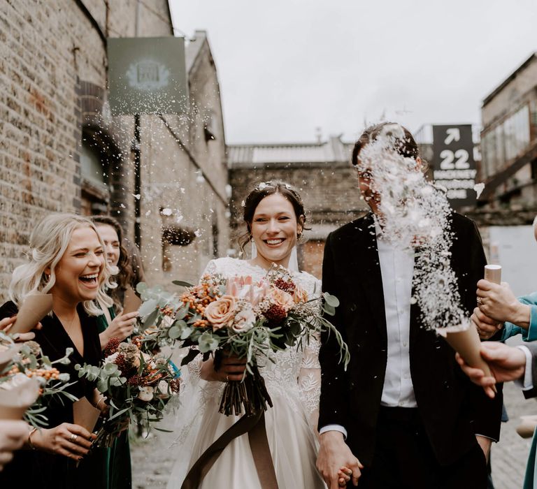 Bride and groom confetti moment