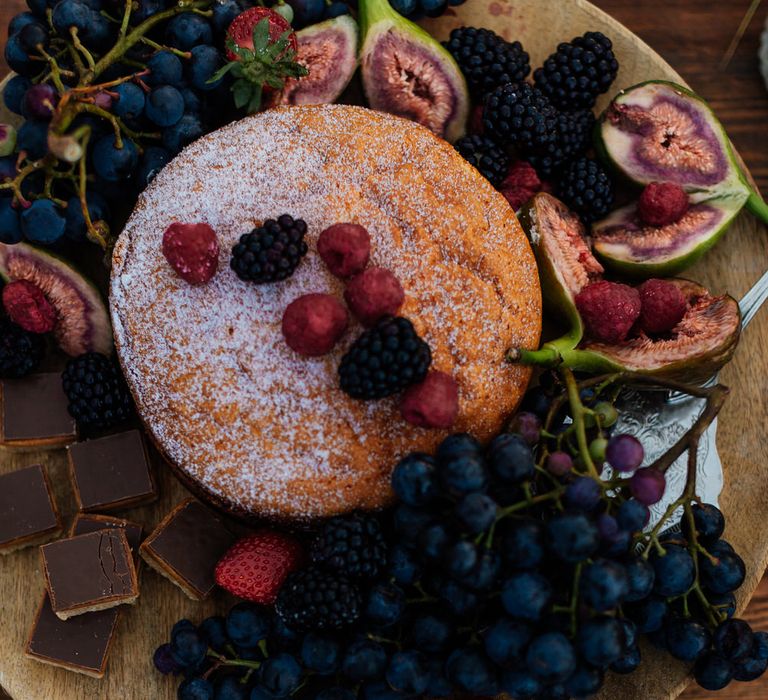 Victoria sponge with grapes and chocolates at beach picnic