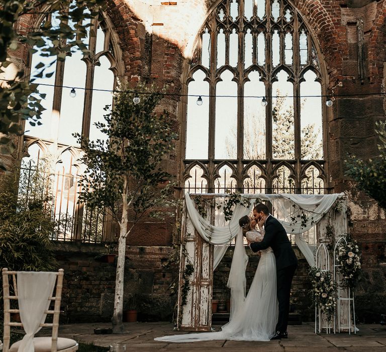 Trees and shabby door wedding altar decor at the bombed out church in Liverpool 