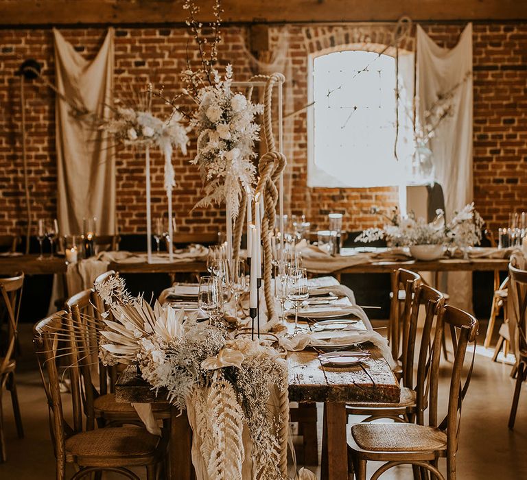 White and beige bohemian luxe wedding decor with dried and fresh flowers, ropes and linens 