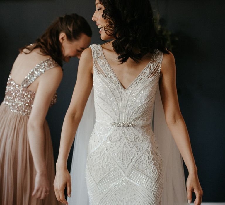 Bride getting ready in plunge neck Eliza Jane Howell wedding dress with embroidered beaded panels