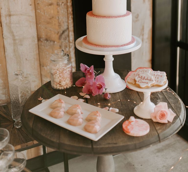 Iced wedding cake with delicate design and pink sugar coating by Chelsea Buns 