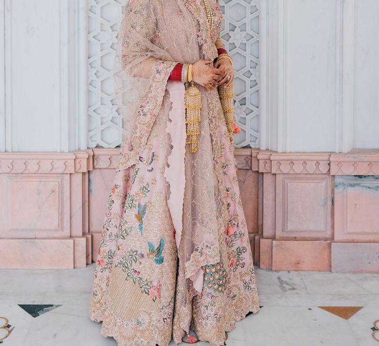 Bride wears pastel coloured lehengha with embellishments 