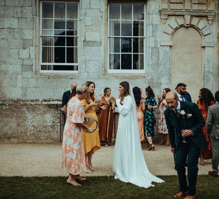 Wedding guests gather outdoors at Elmore Court 