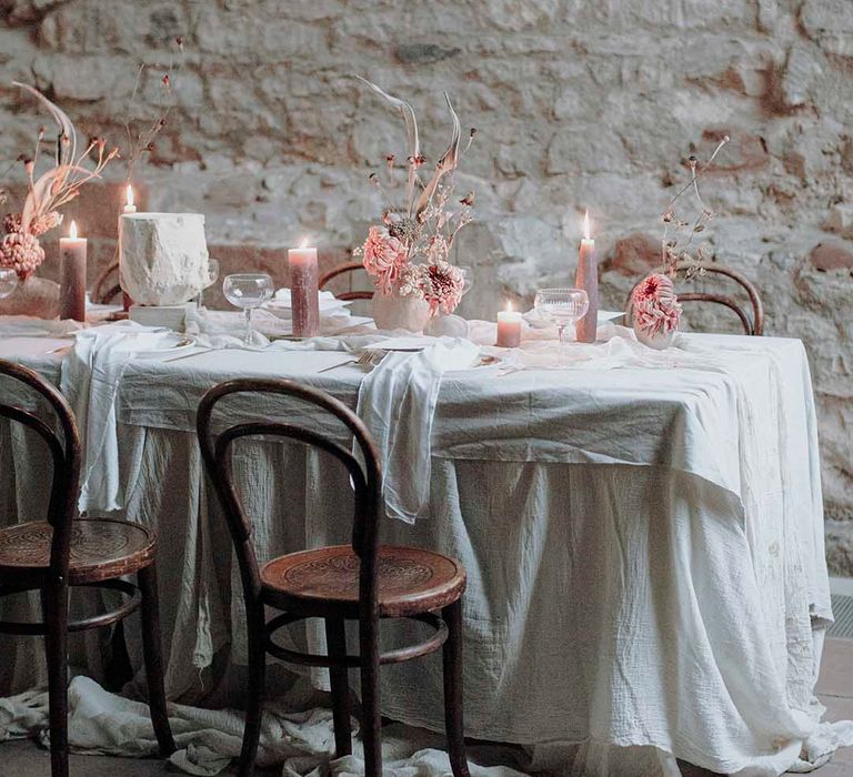 Blackfriars Priory wedding table decor with blush pillar candles and flowers 