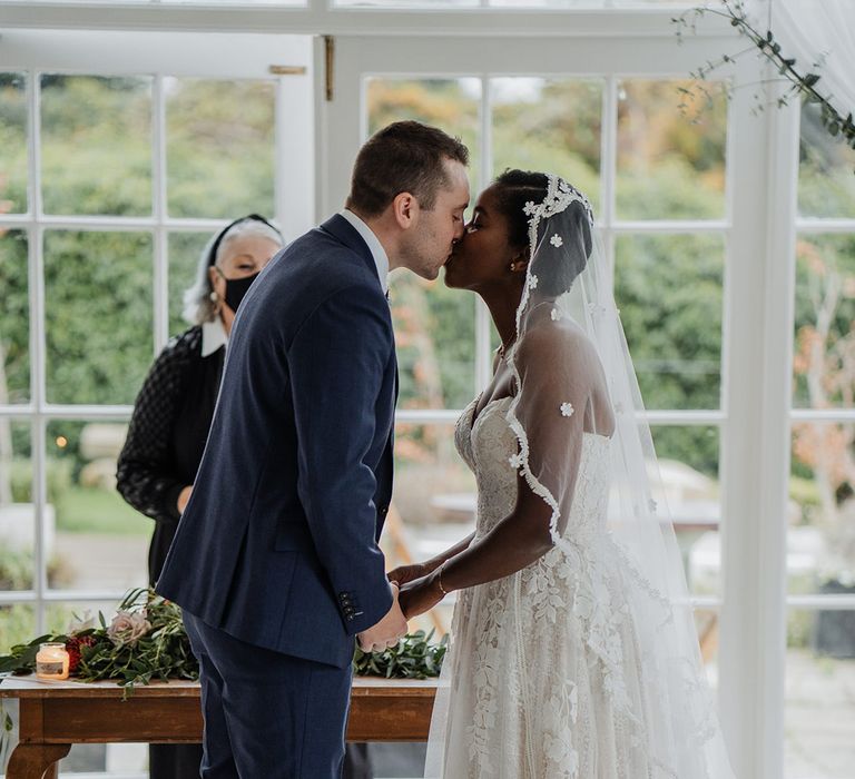 Bride and Groom kiss at wedding ceremony at Horetown House