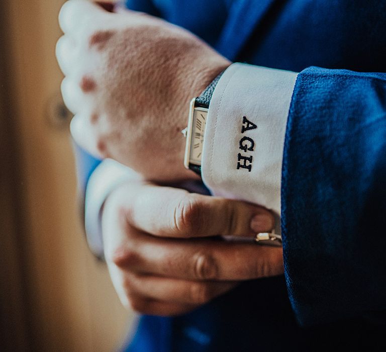 Groom in blue suit jacket with personalised shirt with initials 