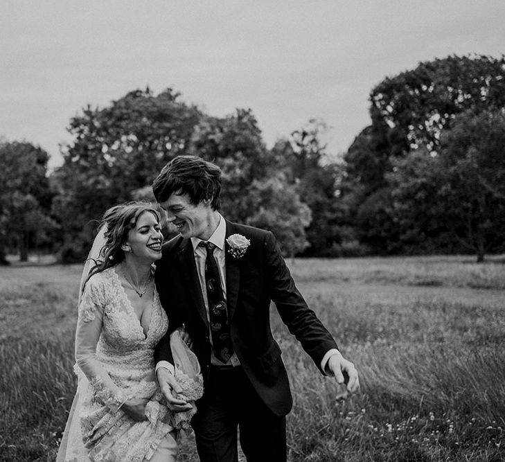 Bride & groom walk outdoors in grounds of Belair House after wedding ceremony in black & white image