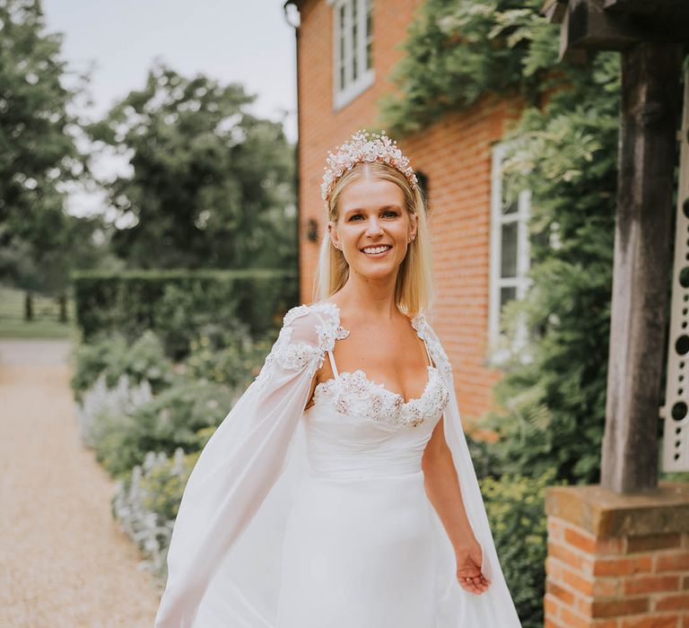 Bride in a handmade wedding dress, cape and crown for her wedding day 