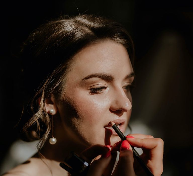 Bride gets her makeup done for her wedding day 